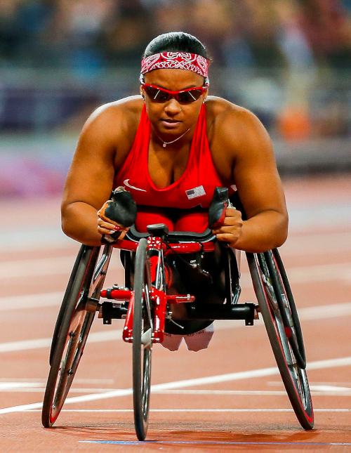 A photograph of Dr. Forber-Pratt at the 2012 Paralympics competing in her racing wheelchair.